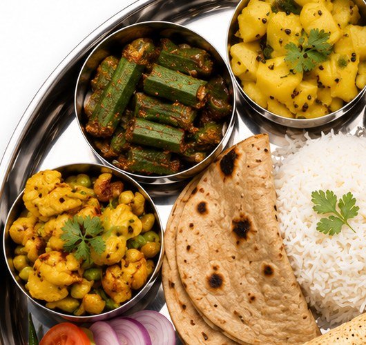 Bhindi, aloo and matar-chole on a steel thali