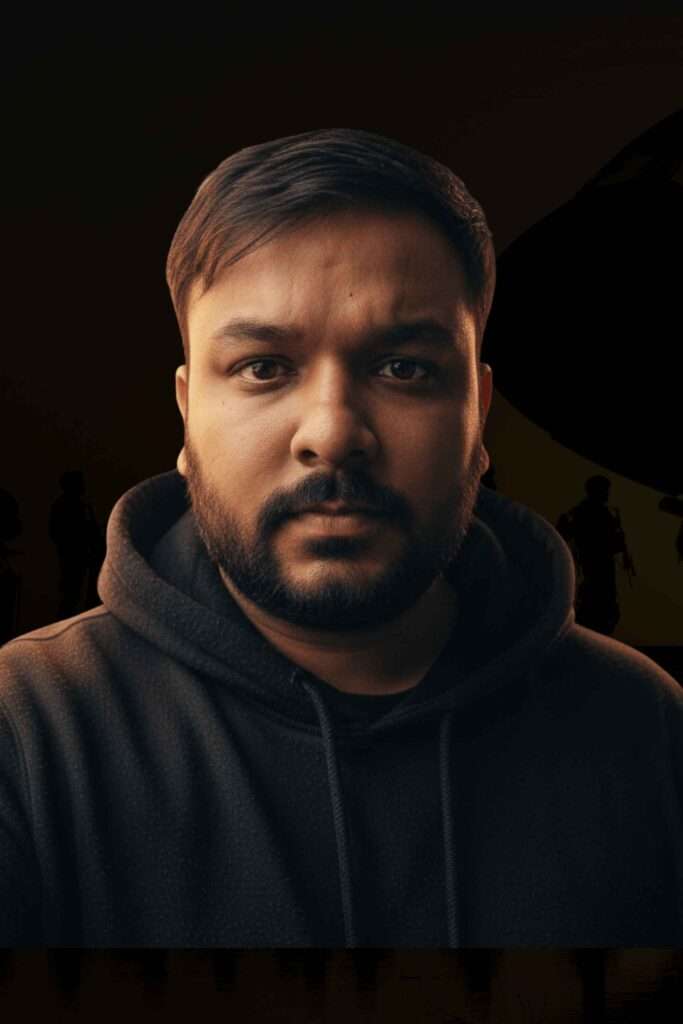 Professional cinematic portrait of Sumit Dhiman, a Senior Multimedia Designer, wearing a black hoodie against a dark background